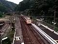 A view of the station platform looking south. The siding can be seen branching off to the left.