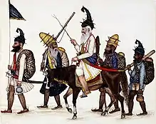 5 early Akali Sikh warriors, one carrying a flag, one on horseback.