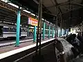 The platform and the building that separates the north and south side of the station with the Prambanan Express train on the left (2003)