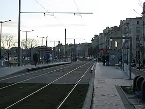 Double tracks in the street flanked by side platforms