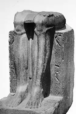 Remains of a statue of the Twelfth Dynasty reappropriated by Hyksos ruler Khyan, with his cartouche  inscribed on the sides over an erasure.