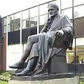 The statue of John Dalton by William Theed outside the university's building in Chester Street