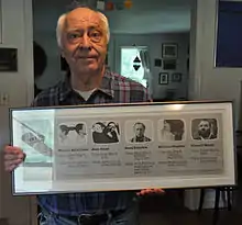 Steve Poleskie holding a poster of "Art Washington 1987" (2015)