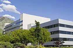 Large, gray, rectangular building with rows of windows lining every other floor