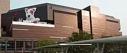 Remodeled bronze exterior in October 2018. White dog with red target around eye above signage that says Target Center