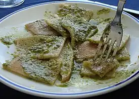 A plate of testaroli with pesto, as served at a trattoria in Pontremoli, Italy