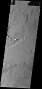 THEMIS image of lava flow plains northeast of Tharsis Tholus. The volcano is surrounded by these Amazonian-aged lava flows from the interior of the Tharsis region to the west.