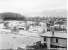 B&W photo of buildings in flood waters