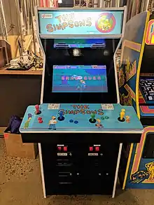 A blue arcade set with The Simpsons characters drawn on it