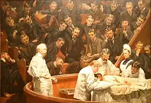 The Agnew Clinic (1889) by Thomas Eakins. Furness is in the top row, center, leaning far to the side.