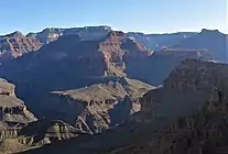 (Viewed from southeast)Tower of Set peak-(center)Horus Temple prominence-(extreme left)Shiva Temple (Grand Canyon), forested tableland summit on the left horizon (photo note: Tower of Set, has the 2 closer prominences)