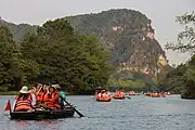 Several tourist boats on a body of water.