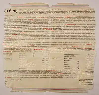 A large piece of parchment paper with detailed, small text of the treaty.