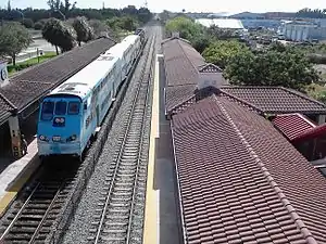 Tri-Rail Cab and Coach Bilevel cars being pushed by 2 GP49H-3s