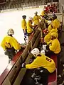 The Fighting Mondales bench during a game against Hamline University