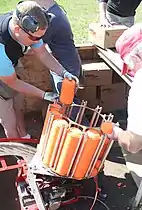 Clay targets being placed in an automatic throwing machine.