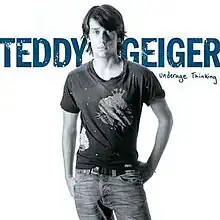 A black-and-white image of Geiger wearing a t-shirt and jeans against a white background, with her name colored in blue behind her. The album's title appears below Geiger's last name.