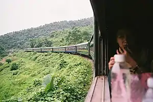 A passenger observes the scenery from her seat.