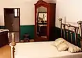 Villa's bedroom. Note pistol hanging from headboard.