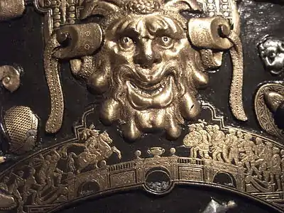 Detail from the Ghisi Shield; a grotesque head in the larger scale above Horatius at the bridge in the smaller