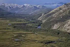 Aerial view of a mountainous landscape above small lakes and a winding river