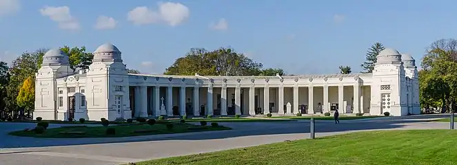 Colonnade on the right, with columbarium and tombstones.