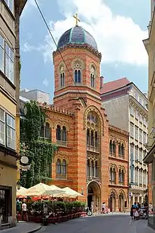 Orange Greek Orthodox church on a city street