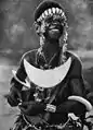 A Solomon Islands woman wearing a shell pectoral resembling a reimiro