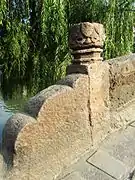 Stone lotus on the top of a baluster column