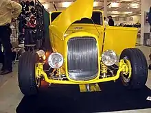 Deuce roadster with a bobbed frame, dropped axle, disc brakes, and coilovers. Note the contrast with the stock frame rails.