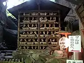 Rows of tiny votive torii donated by the faithful.