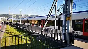 Red-and-white train at side platform