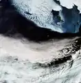 In the top-right corner of the image is Alaska's mainland blanketed with snow, as well as Nunivak Island. At the centre of the image are the islands of Saint Paul and Saint George – part of the Pribilof Islands. Also note the von Kármán vortex street (swirly clouds) in the middle right.