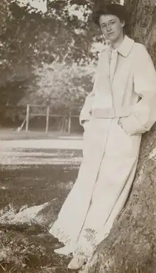 A picture of Theodora McCormick Du Bois standing against a tree.