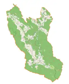 Mapa konturowa gminy Komańcza, blisko centrum na dole znajduje się punkt z opisem „Smolnik, cerkiew”