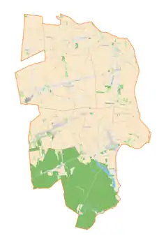 Mapa konturowa gminy Mokrsko, blisko centrum na lewo u góry znajduje się punkt z opisem „Mokrsko Szosa”