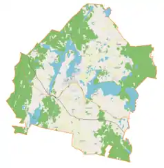 Mapa konturowa gminy Pasym, po prawej nieco u góry znajduje się owalna plamka nieco zaostrzona i wystająca na lewo w swoim dolnym rogu z opisem „Okrągłe Jezioro”