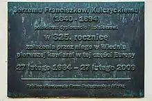 Tablica upamiętniająca Jerzego Franciszka Kulczyckiego, wmurowana w elewację kamienicy od strony ul. św. Tomasza