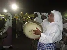 Men in white robes with instruments